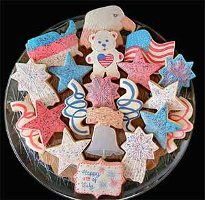 Fourth of July cookie tray: eagle, flag, US, stars, fireworks, liberty bell. teddy bear, and string.