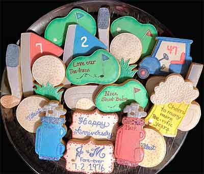 Anniversary cookies: Golf clubs, flags, golf greens, golf cart, putters and beer.