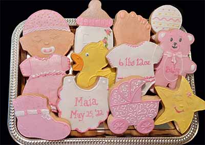 Baby cookie tray: Baby, bottle, foot, rattle, duck, onesie, bib,dress, duck, bear, bootie, baby carriage, and star.