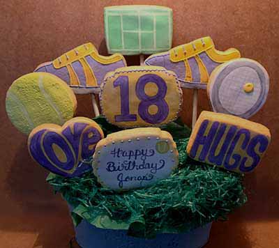 Birthday cookie Bouquet: Tennis court, ball, racket and tennis shoes.