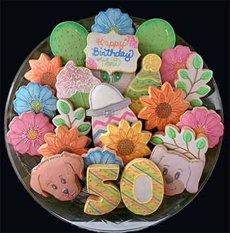 Birthday cookie tray: flowers,branches,dogs balloons, numbers, and cupcake.