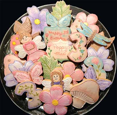 Birthday cookie tray: Flowers, butterflies, branches,mushrooms, fairies, dragon flies, branches and bird.