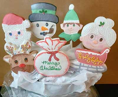 Christmas cookie bouquet: Mr. and Mrs. Claus, Snowman, reindeer, elf, sleigh, and bag.