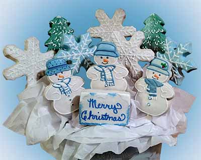 Cookies on a stick: Fir trees, snowflakes, snowmen, and a rectangular cookie.