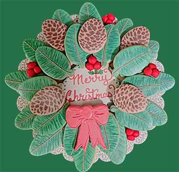 Cookies on a decorative plate arranged to look like a Christmas wreath with fondant berries.