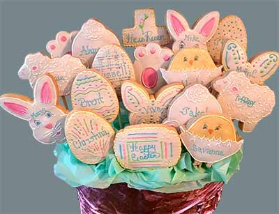 Easter cookie bouquet: Cross, bunnies, sheep, chicks, butterfly, and eggs.