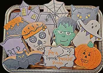 Halloween cookie tray: ghost, jack o'lantern. tombstone, casket, house, skull and Frankenstein. caldron, grim reaper, spider web.