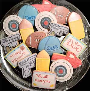 Retirement cookie tray: Bullseyes, guns, bullets, football, caps, and pick up.