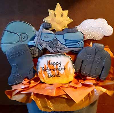 Retirement cookie bouquet: Helmet, sun, cloud, motorcycle, jacket, and boot.