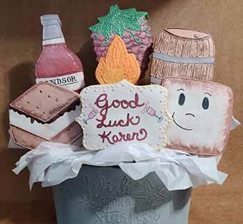 Retirement Cookie tray: Bouquet: Bottle of wine, Grapes, wooden barrel, camp fire, smores, ad marshmallow.