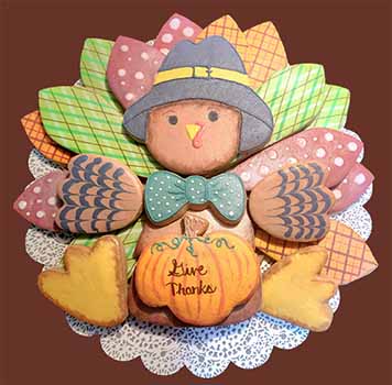 Turkey cookie plate: Cookies arranged to look like a turkey with a hat and pumpkin.