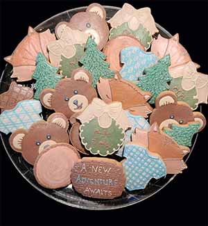 Baby cookie tray: bears, foxes, trees, onsies, and bibs.