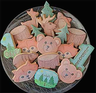 Birthday cookie tray: fox, bear, deer, tree stumps and number ones.