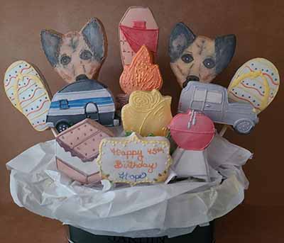 Birthday cookie bouquet:  Dogs, camper, flipflop, rose, jeep, grill, smores, campfire, and sleeping bag.