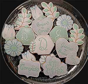 Wedding cookie tray: Flowers, date, monogram, rosebuds, hearts, and branches.