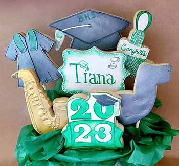 Graduation Cookie Bouquet: Graduation gown, hat, tassel,, saxaphone, music noteand year.