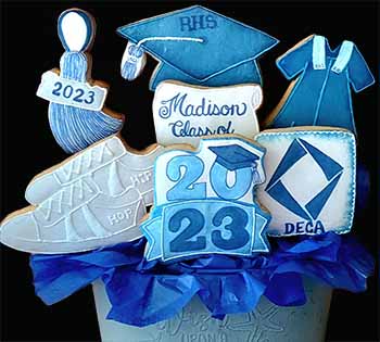 Graduation cookie bouquet: Cap, gown, tennis shoes and year.