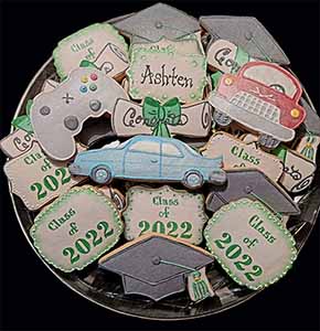 Graduation cookie tray: Cars, graduation hats, diplomas, gaming control, and year.