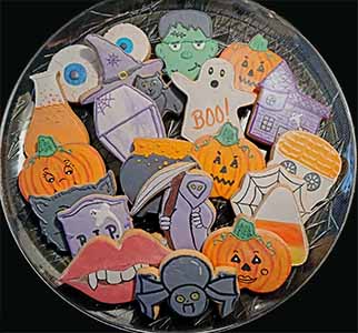 Halloween cookie tray: eyes, cat, lips with fangs, ghost, jack o'lantern. tombstone, casket, house. caldron, grim reaper, test tube, spider and web.