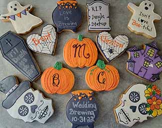 Halloween wedding theme cookie tray: Skull, cauldrons, ghost, haunted house, pumpkins, hearts, tombstone, coffin, and numbers.