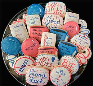 Retirement cookie tray: Balloons, notebook pages, coffee cups, string, and clock.