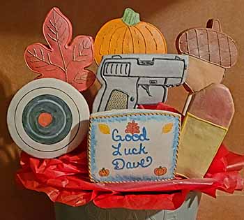 Retirement cookie bouquet: Leaf, pumpkin, acorn, bullseye, gun, and bullet.