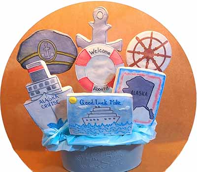 Retirement cookie bouquet: Cptians hat, ship, anchor, life perserve, ship steerig wheel and Alaska.