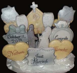 Wedding cookie bouquet: Church, champagne glasses, roses, bells, hearts, bride and groom, and ring. 